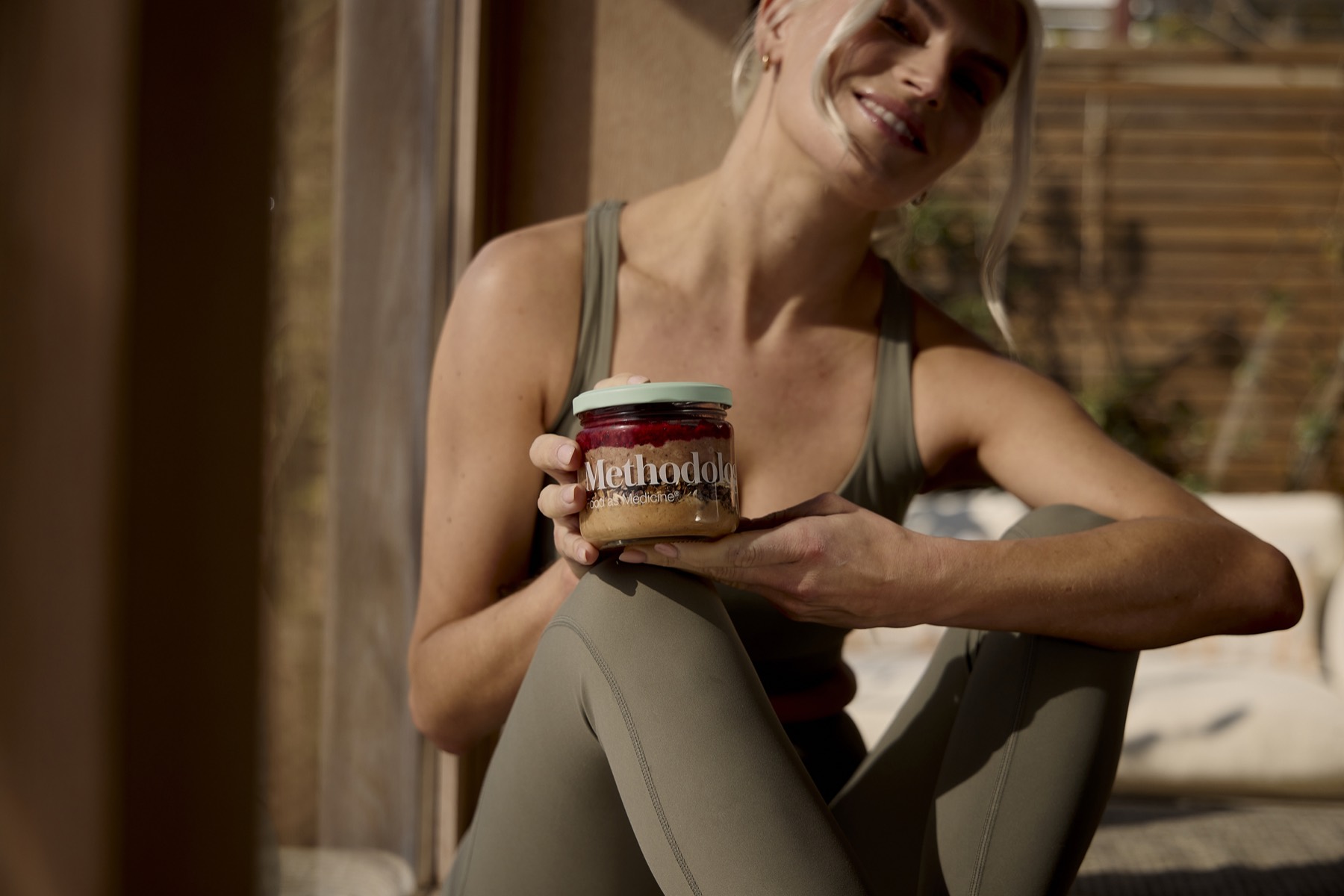 A person holding a Methodology Signature meal in a glass jar