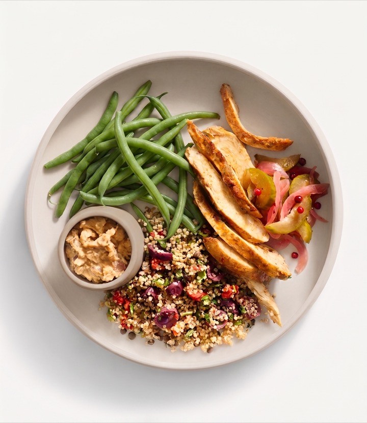 Herbed Chicken Shawarma Bowl: olive and date brined chicken breast, herbed quinoa salad, haricot vert, tzatziki, and Mediterranean pickled vegetables